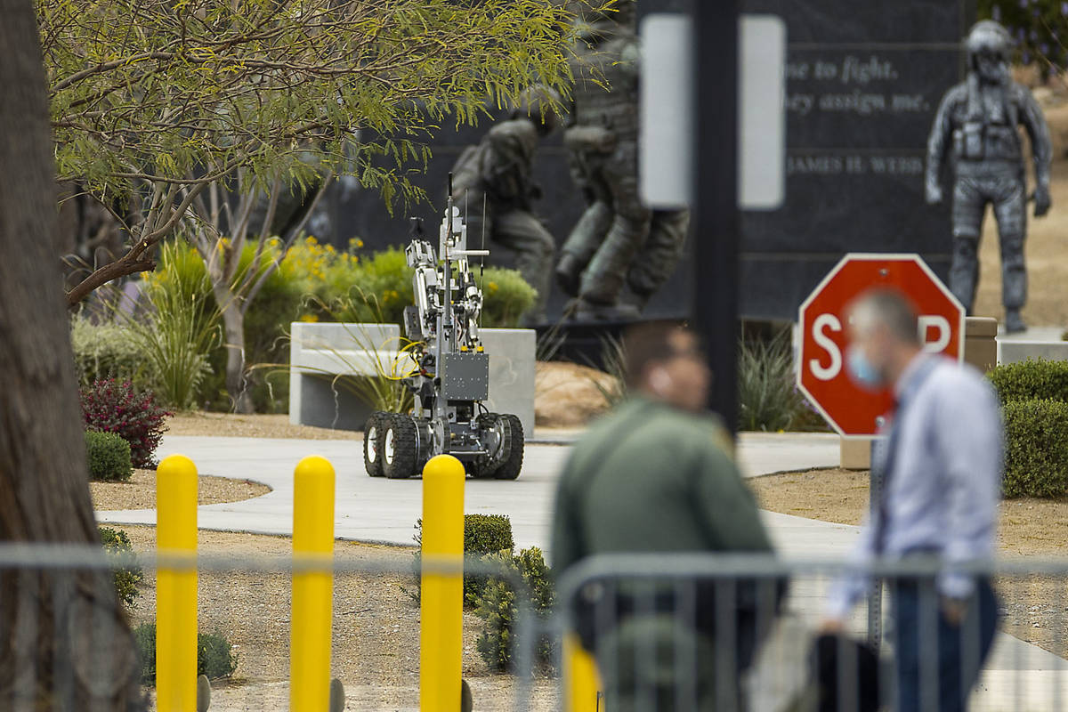 A bomb squad robot rolls into place to check out a suspicious item on the ground at the Nevada ...