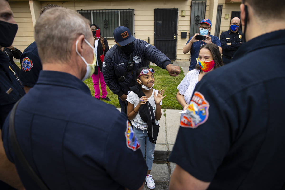 Lynn Armstrong, right, and her granddaughter, Karlycia Osorio, 8, talk with the firefighters th ...