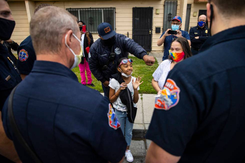 Lynn Armstrong, right, and her granddaughter, Karlycia Osorio, 8, talk with the firefighters th ...