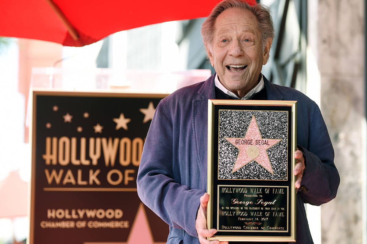 Actor George Segal poses with a replica of his star at a ceremony honoring him on the Hollywood ...