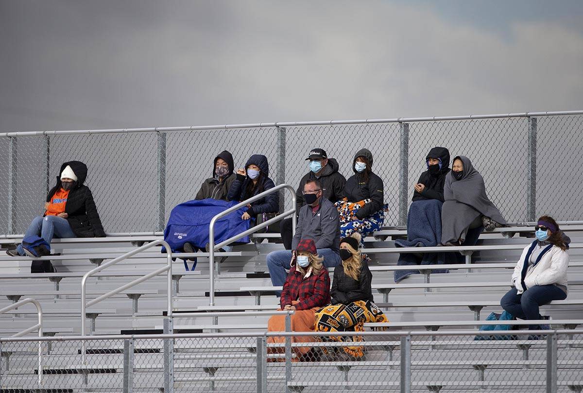 Bishop Gorman fans are dressed for cold weather while watching the boys varsity high school soc ...