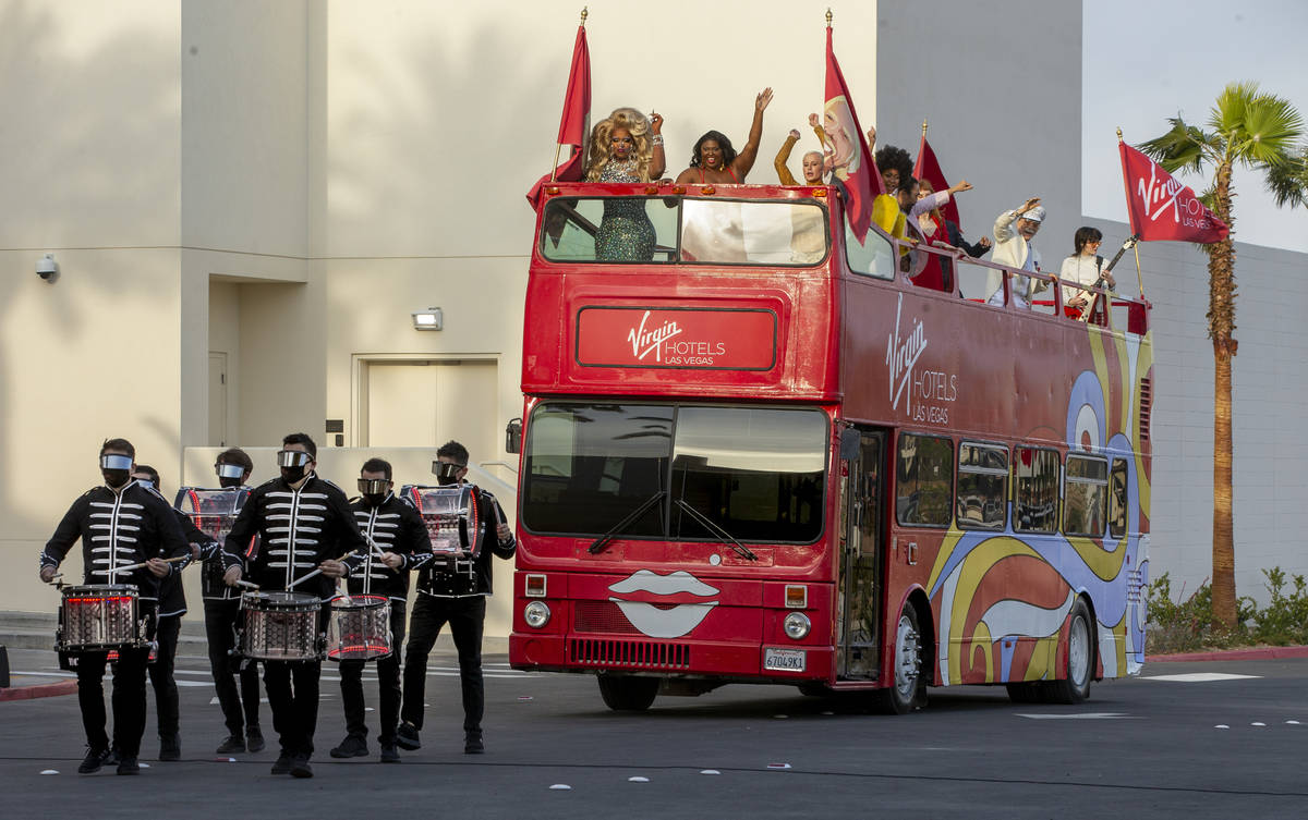 Drummers followed by a double-decker bus with dancers atop arrives during the Virgin Hotels Las ...