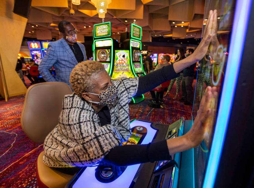 Noreen McRoyal gets her hands onto the Abundant Fortune slot machine for extra luck as her husb ...