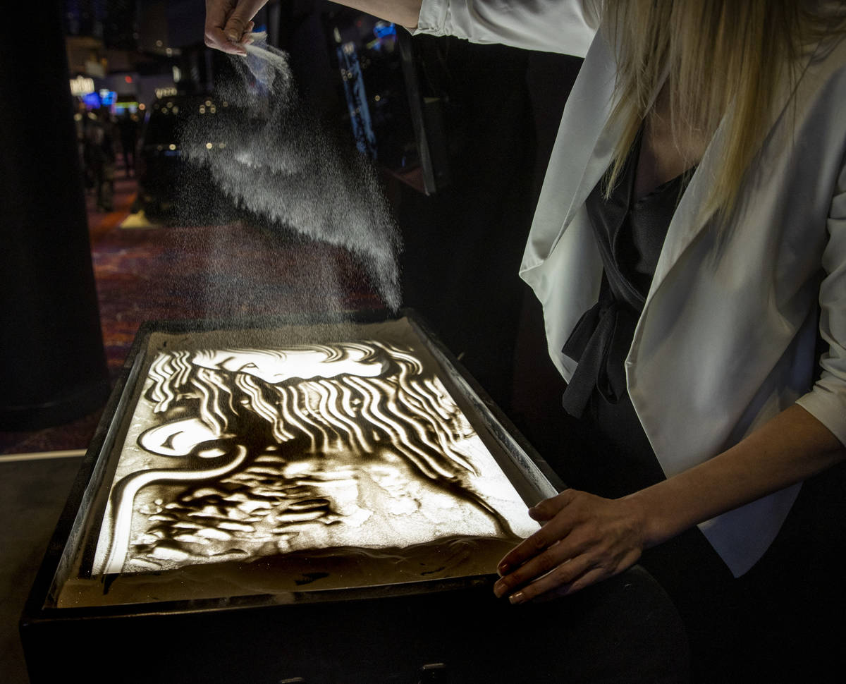 Sand artist Teresa Kae creates and evolving art piece for visitors about the casino floor durin ...