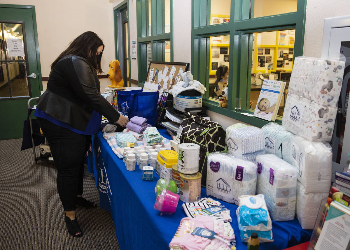Abby Quinn, chief community relation officer at HELP of Southern Nevada, displays maternity and ...