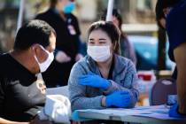 Debbie Min, right, a physician assistant student from Touro University, talks to Hugo Fernandez ...