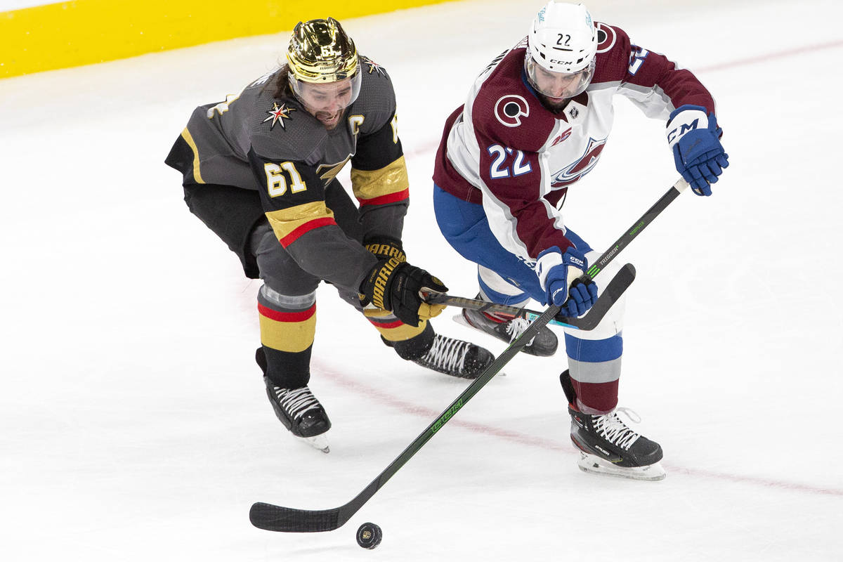 Golden Knights right wing Mark Stone (61) and Colorado Avalanche defenseman Conor Timmins (22) ...