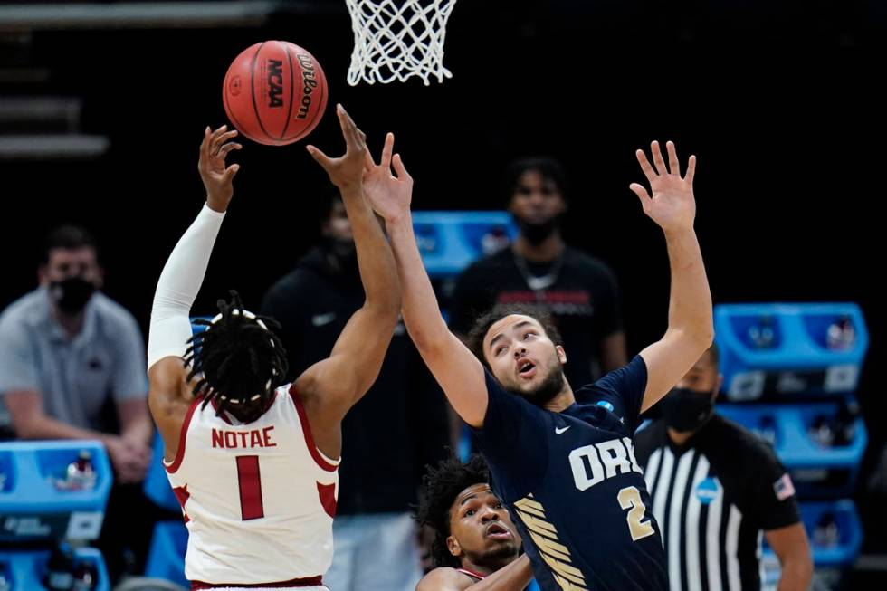 Oral Roberts guard Kareem Thompson (2) tries to block a shot by Arkansas guard JD Notae (1) dur ...