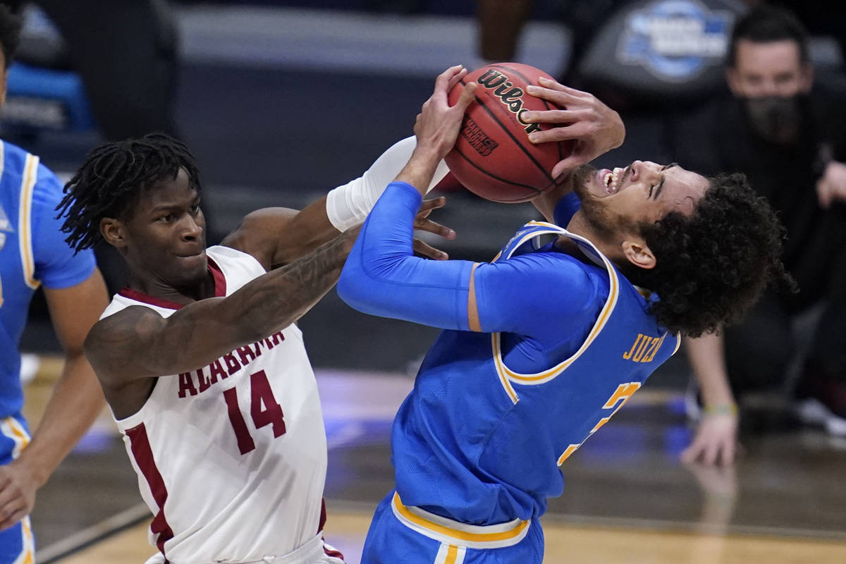 Alabama guard Keon Ellis (14) ties up UCLA guard Johnny Juzang (3) in the first half of a Sweet ...