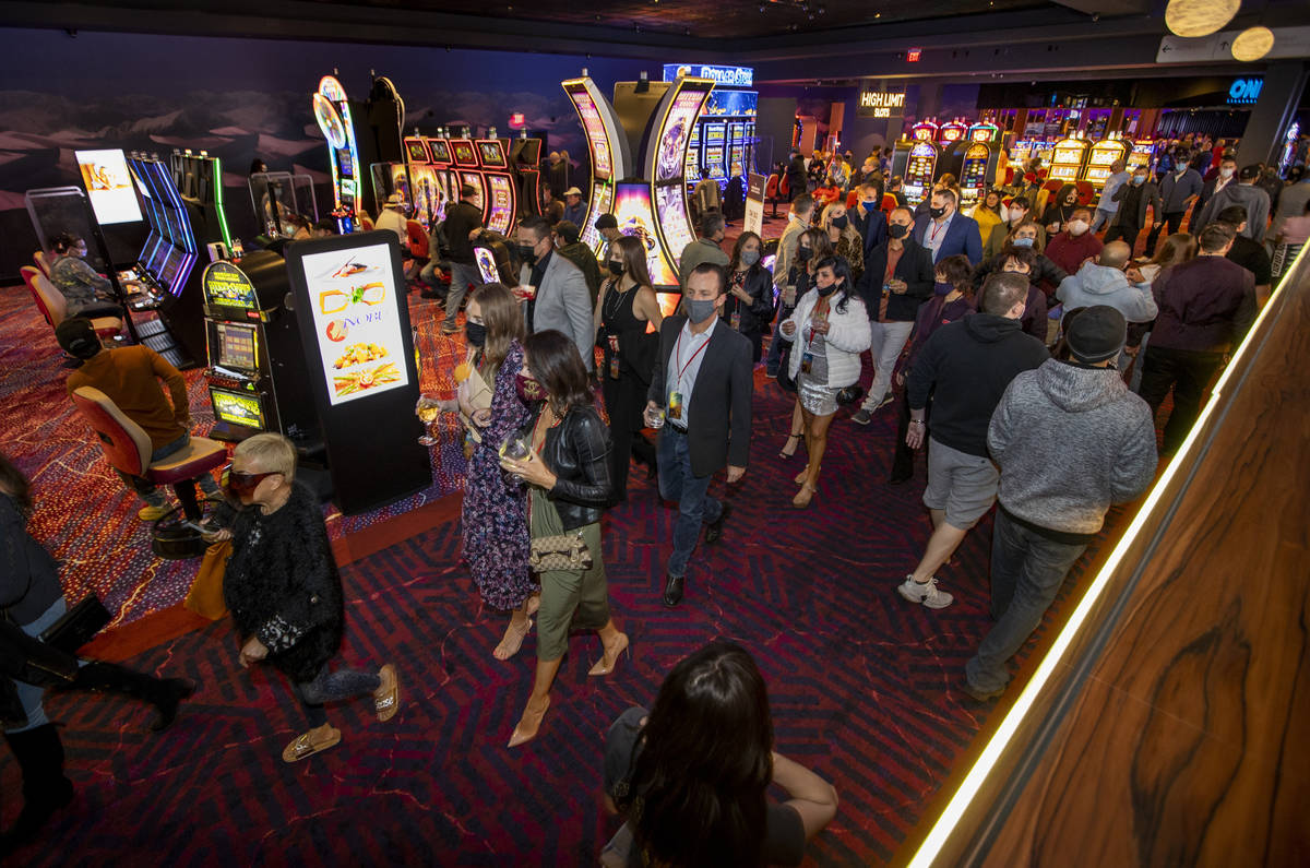 The crowd continues to get larger and flows about the casino floor during the Virgin Hotels Las ...