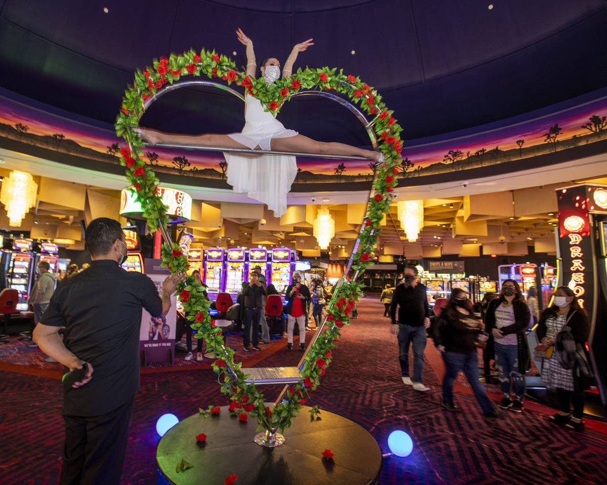 Aerialist Svetlana Ghetman spins on a rotating heart within the middle of the casino floor duri ...