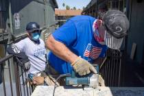 Allan Kennedy, center, member of the Carpenters Local 1977 union, volunteers to remodel units f ...