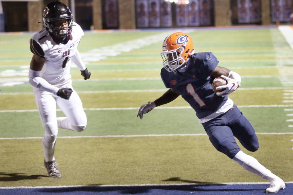 Bishop Gorman's Zachariah Branch (1) runs the ball for a touchdown as Faith Lutheran's Joshua G ...