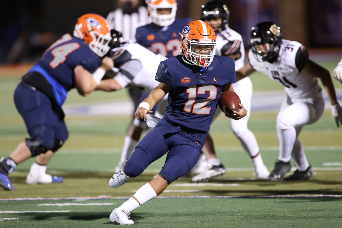 Bishop Gorman's Micah Alejado (12) runs the ball against Faith Lutheran during the second quart ...