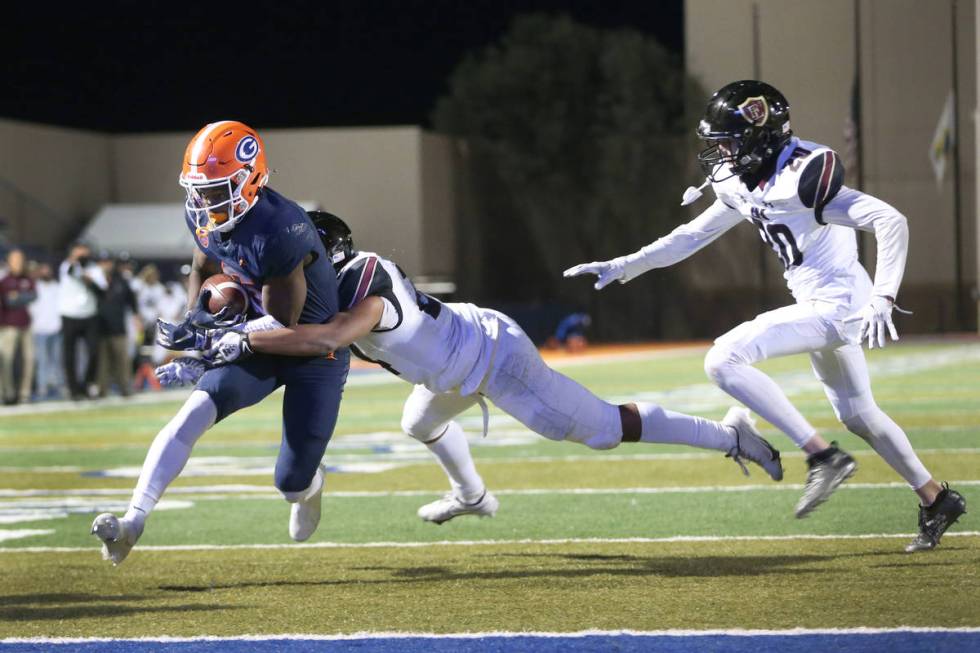 Bishop Gorman's Jonathan Brady (6) runs the ball for a touchdown under pressure from Faith Luth ...