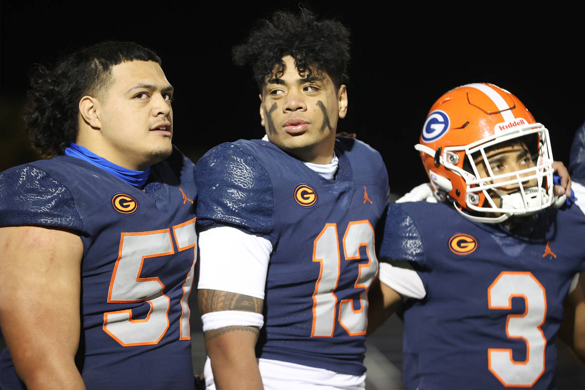 Bishop Gorman's Tafao Amataga (57), Maa Gaoteote (13) and Cam'ron Barfield (3), sign in celebra ...