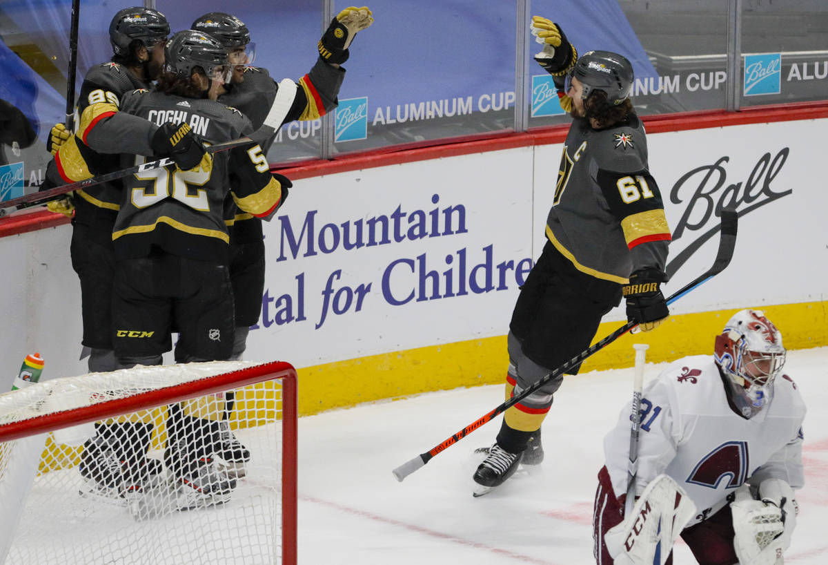 Vegas Golden Knights right wing Alex Tuch (89) and defenseman Dylan Coghlan (52) hug Golden Kni ...