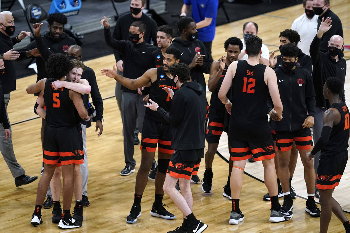 Oregon State players celebrate after a Sweet 16 game against Loyola Chicago in the NCAA men's c ...