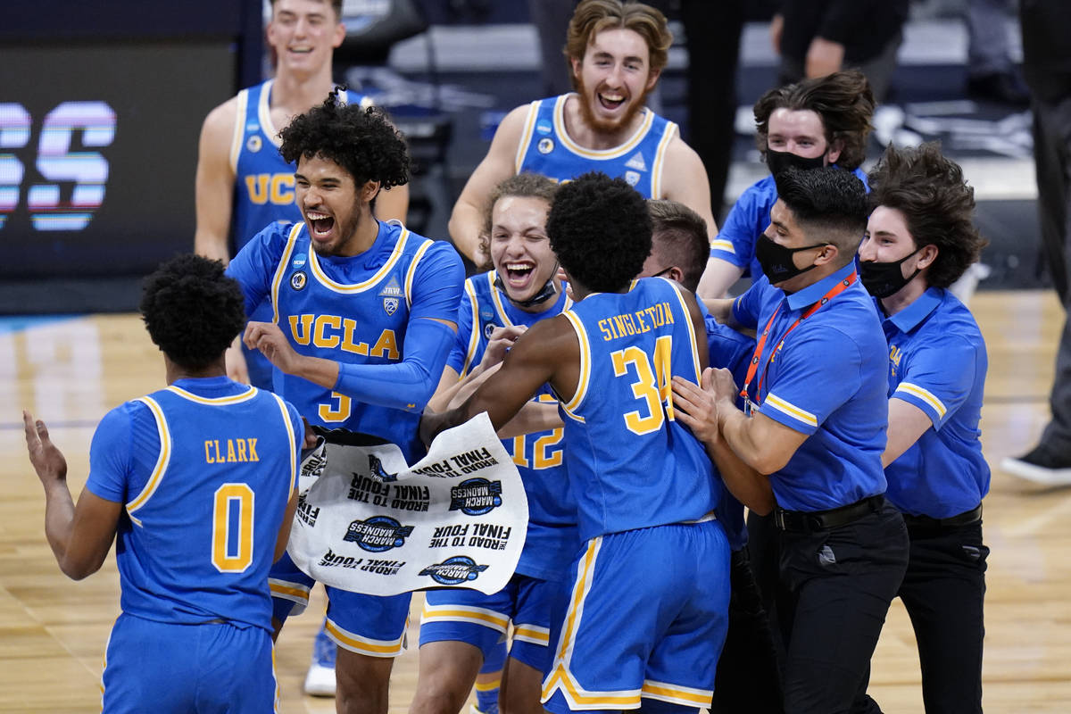 UCLA players celebrate after beating Alabama 88-78 in overtime of a Sweet 16 game in the NCAA m ...