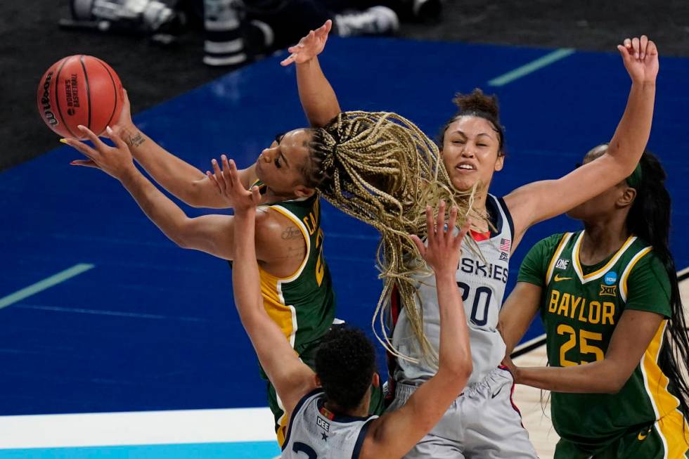 Baylor guard DiJonai Carrington, left, drives to the basket against UConn forward Olivia Nelson ...