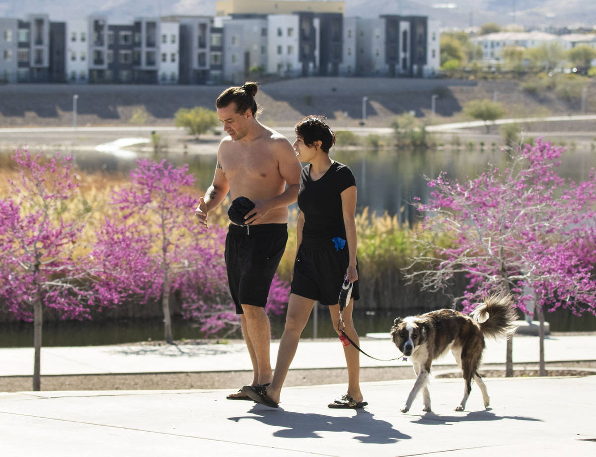 Alex Donaldson walks with his girlfriend April Rosales and their dog Anakin at Cornerstone Park ...