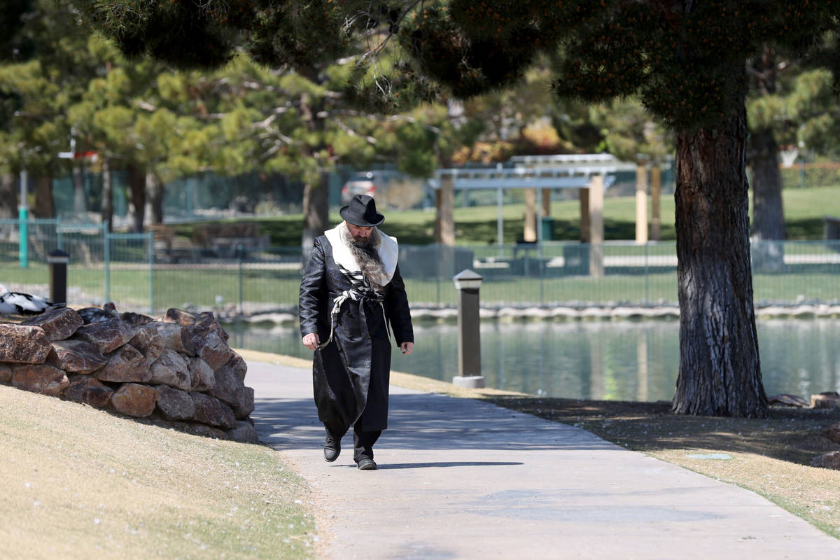A person who was not able to give his name walks home from Beit Allon Chabad Community Center a ...