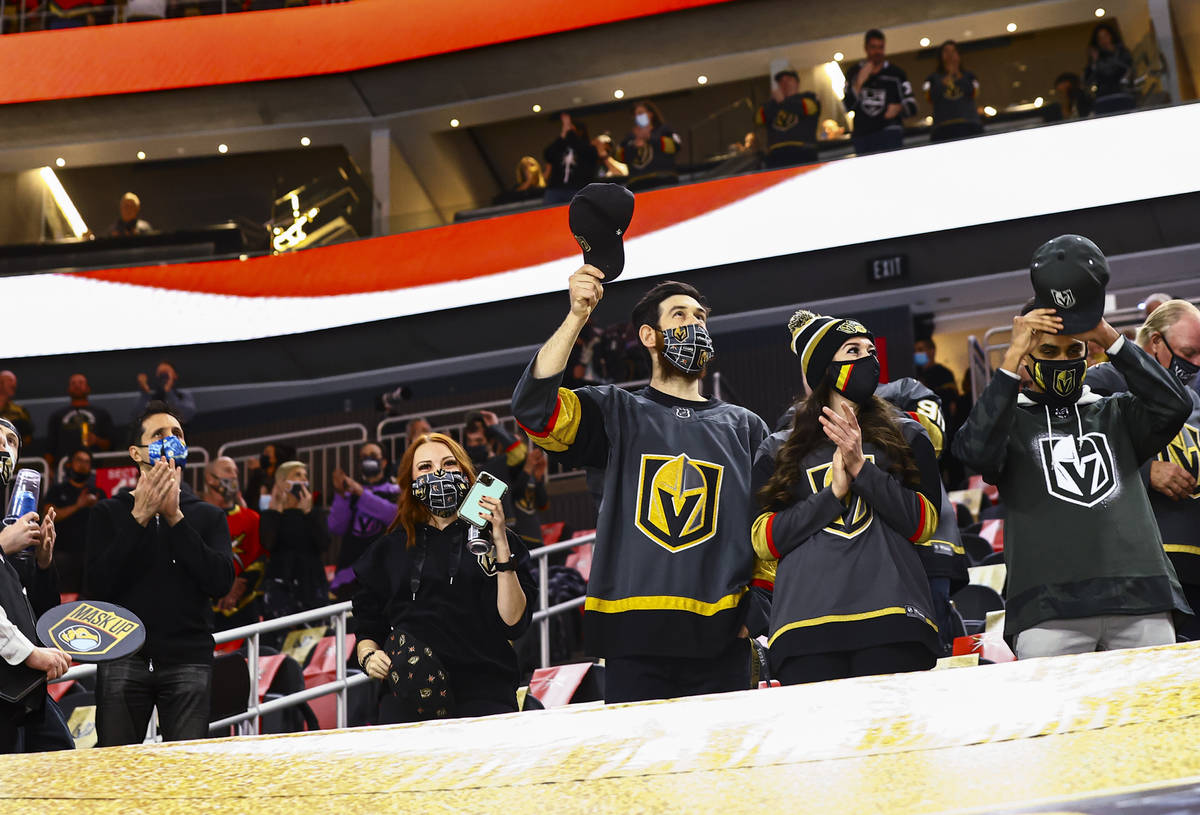 Golden Knights fans cheer after the national anthem before the first period of an NHL hockey ga ...