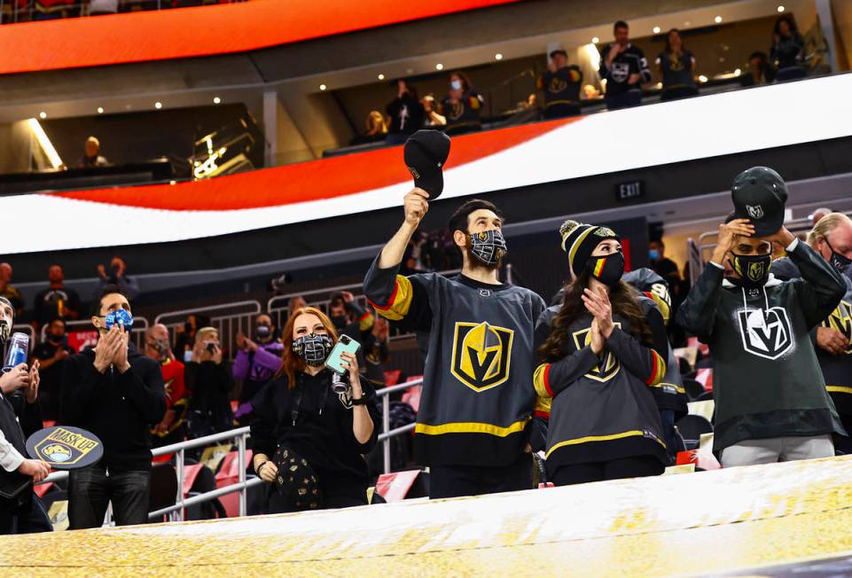 Golden Knights fans cheer after the national anthem before the first period of an NHL hockey ga ...