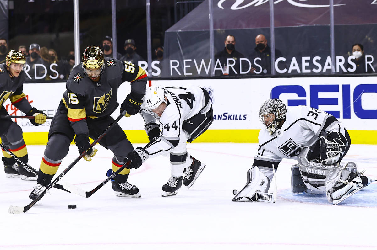 Golden Knights' Keegan Kolesar (55) moves the puck in front of Los Angeles Kings' Mikey Anderso ...