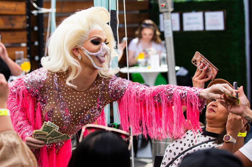 Drag queen Elliott Puckett, who goes by Elliott with 2 Ts, collects tip while performing during ...