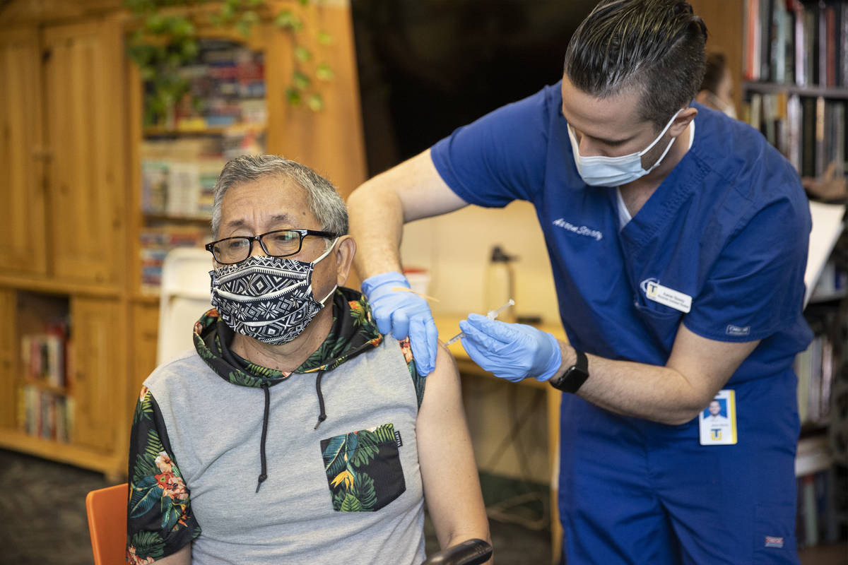 Leonardo Terravova, 66, receives the COVID-19 vaccine from Touro University Nevada physician as ...