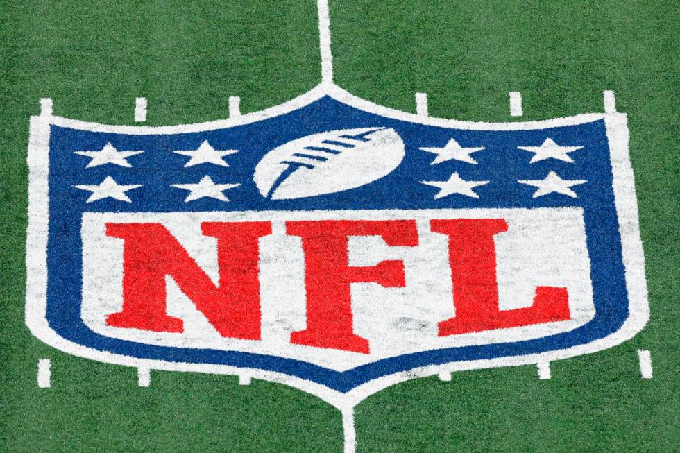 FILE - In this Nov. 2, 2020, file photo, the NFL logo is displayed at midfield during an NFL f ...
