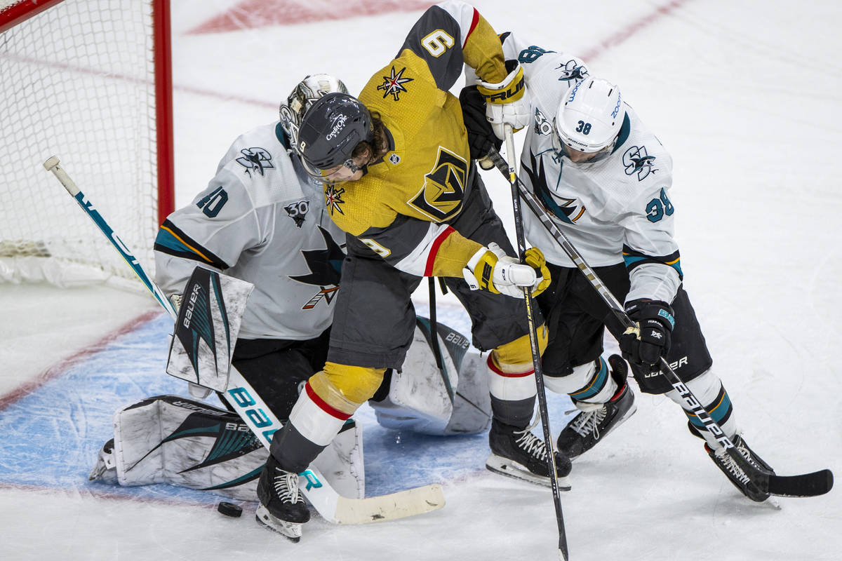 Golden Knights center Cody Glass (9) looks to get the puck into the net past San Jose Sharks go ...