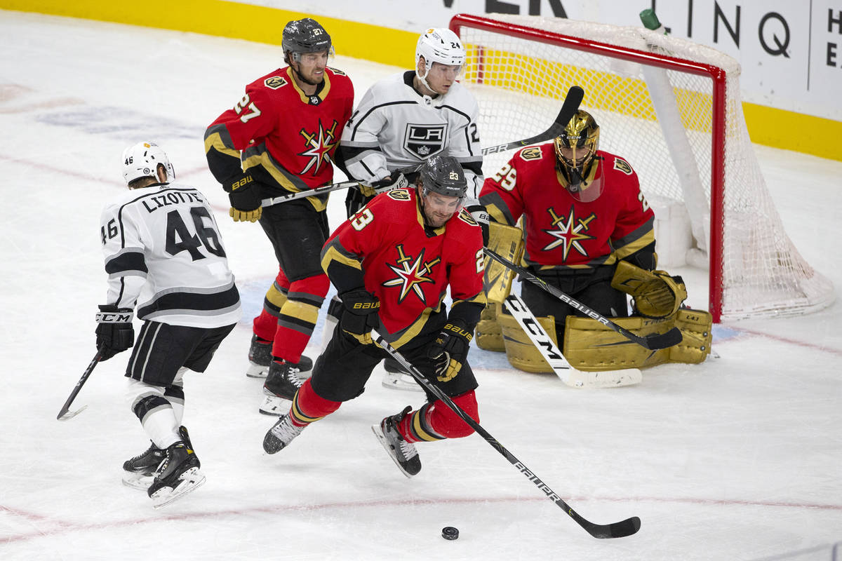 Golden Knights defenseman Alec Martinez (23) skates for the puck after an attempted goal by the ...
