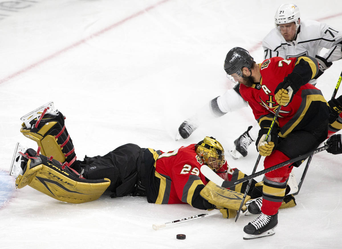 Golden Knights goaltender Marc-Andre Fleury (29) dives to save the puck while Golden Knights de ...