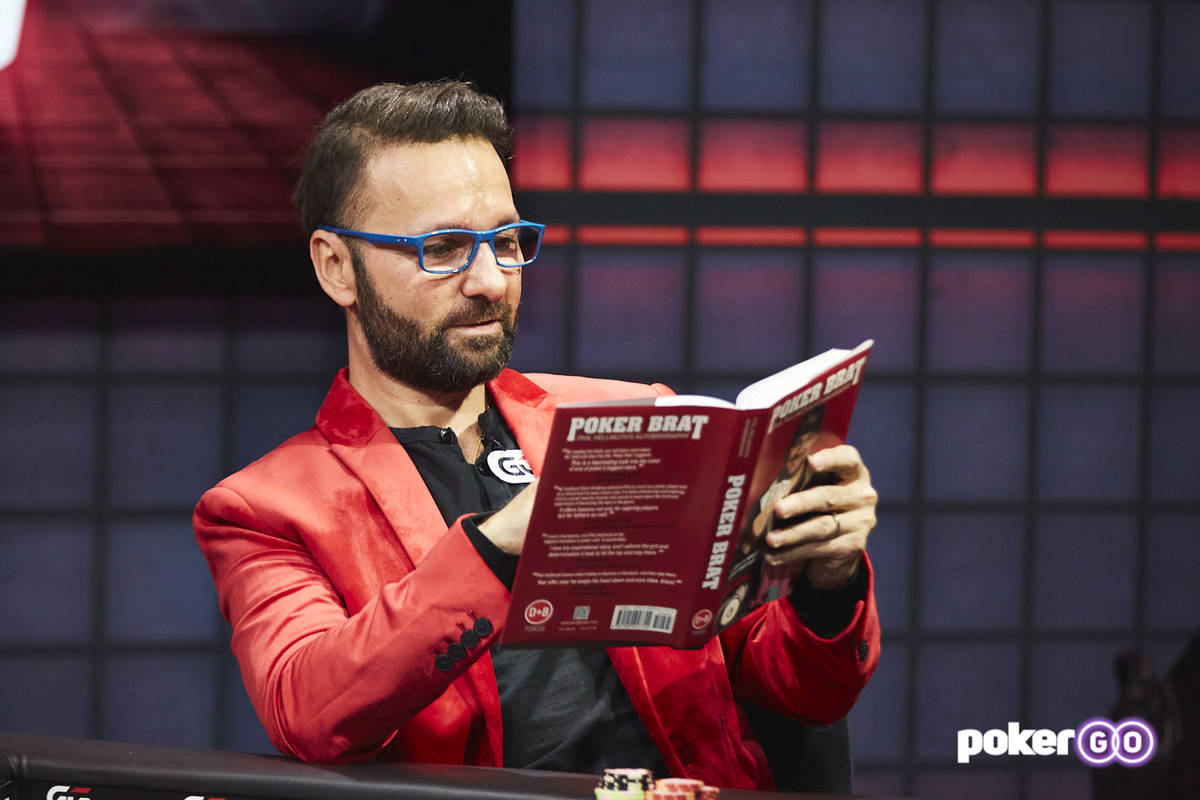 Daniel Negreanu reads one of Phil Hellmuth's books during their "High Stakes Duel" broadcast We ...
