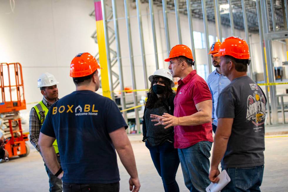 Paolo Tiramani, founder and CEO of Boxabl, fourth from left, talks with team members in their m ...