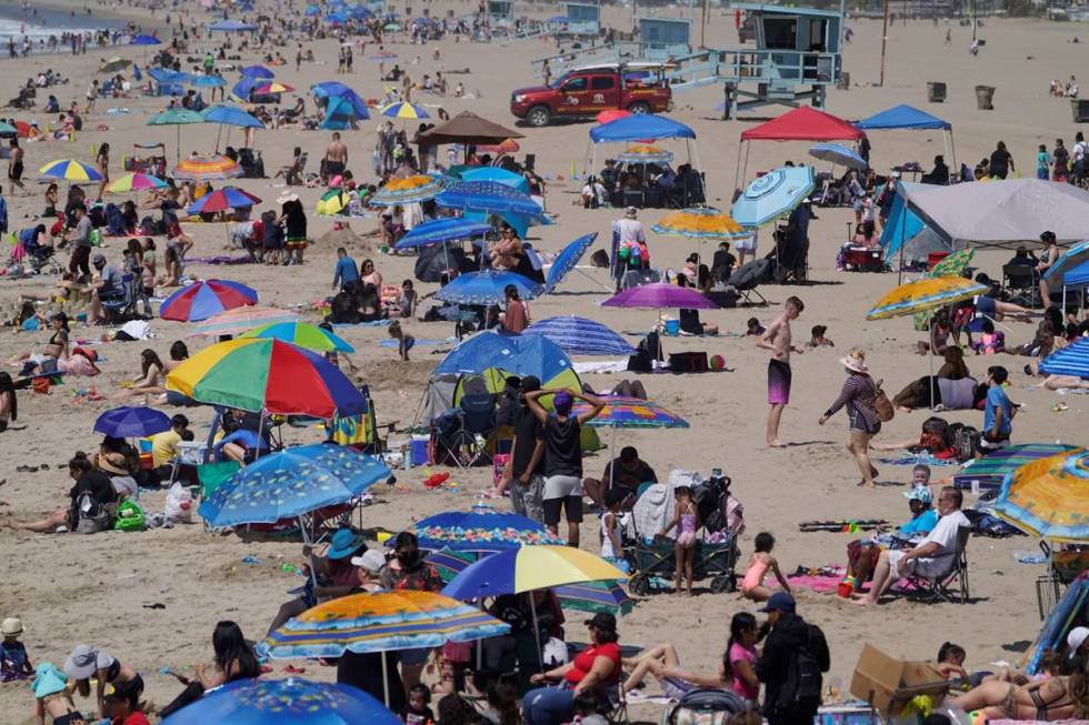 People enjoy the hot weather on Santa Monica Beach in Santa Monica, Calif., Wednesday, March 31 ...