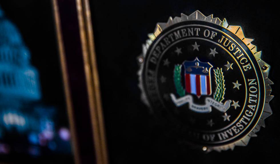 Retired FBI agent Jim Stern's framed badge at his home in Las Vegas on Friday, Feb. 19, 2021. ( ...
