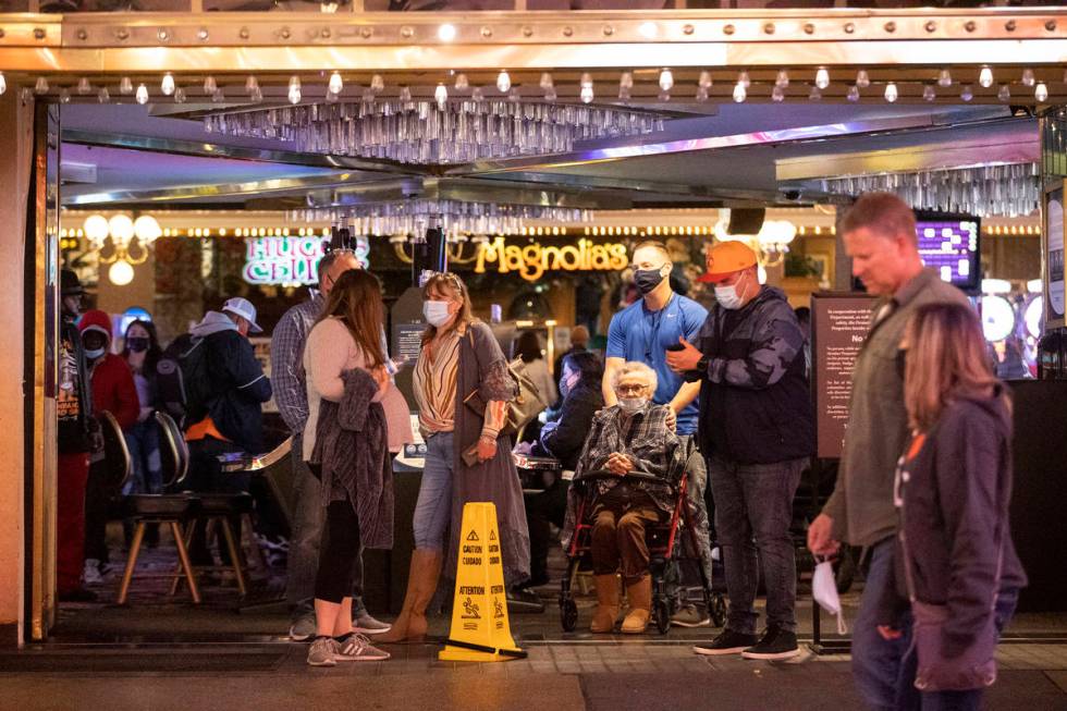 People visit the Fremont Street Experience in Las Vegas, on Friday, March 12, 2021. (Erik Verdu ...