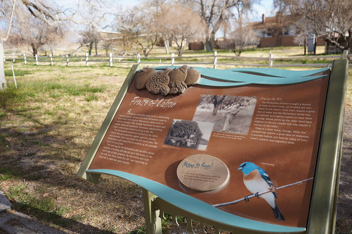 A view of Corn Creek’s orchard and an informational panel that shares some of the former ...
