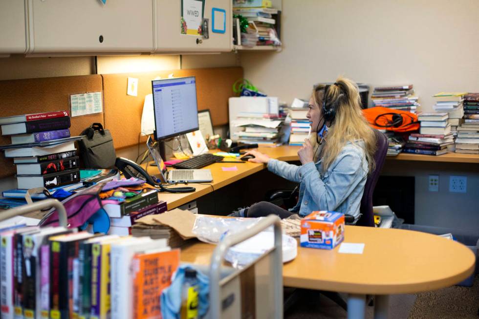 Library assistant Sonja Grace works a phone line that helps people get vaccines at Aliante Libr ...