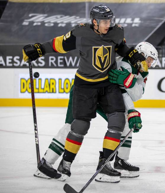 Golden Knights left wing Tomas Nosek (92) battles for the puck with Minnesota Wild defenseman I ...