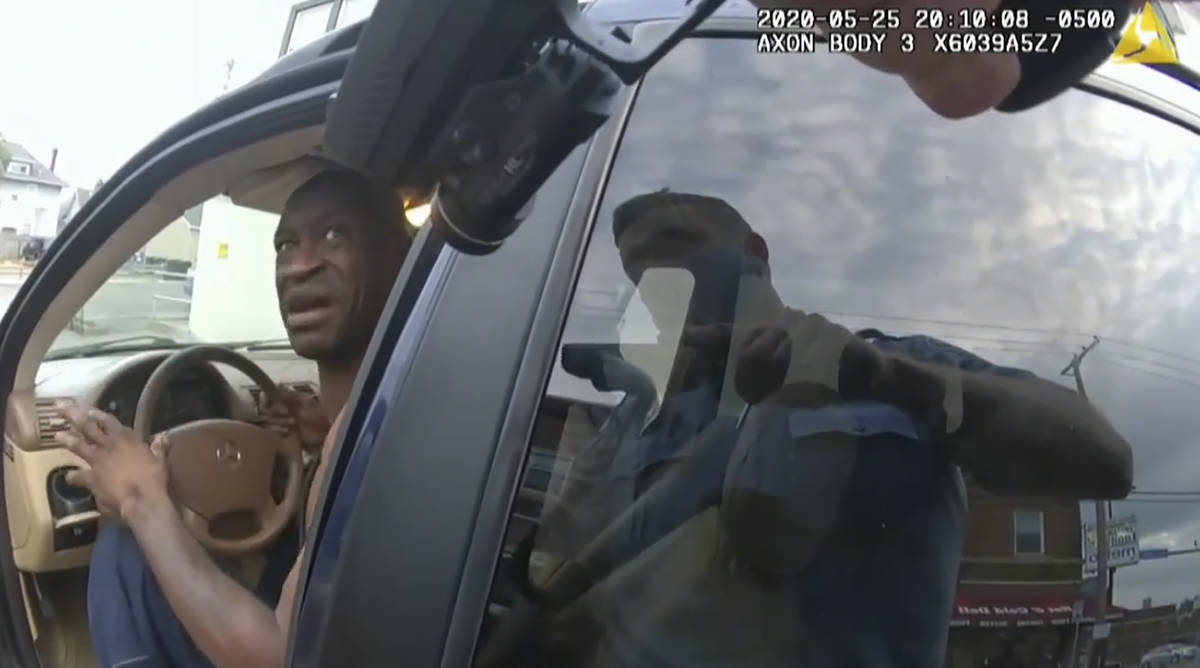 In this image from police body cam video, a Minneapolis police officer approaches George Floyd ...