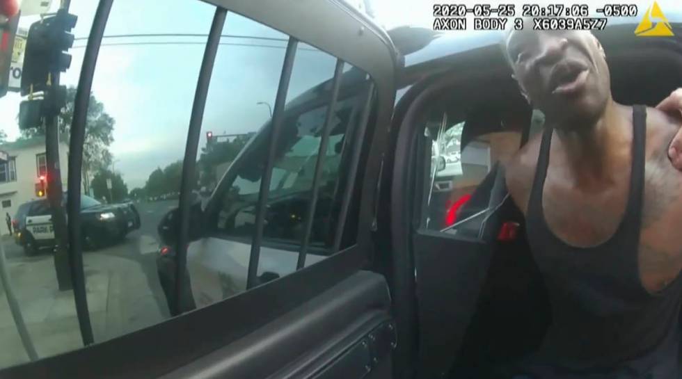 In this image from police body cam video, Minneapolis police officers attempt to place George F ...
