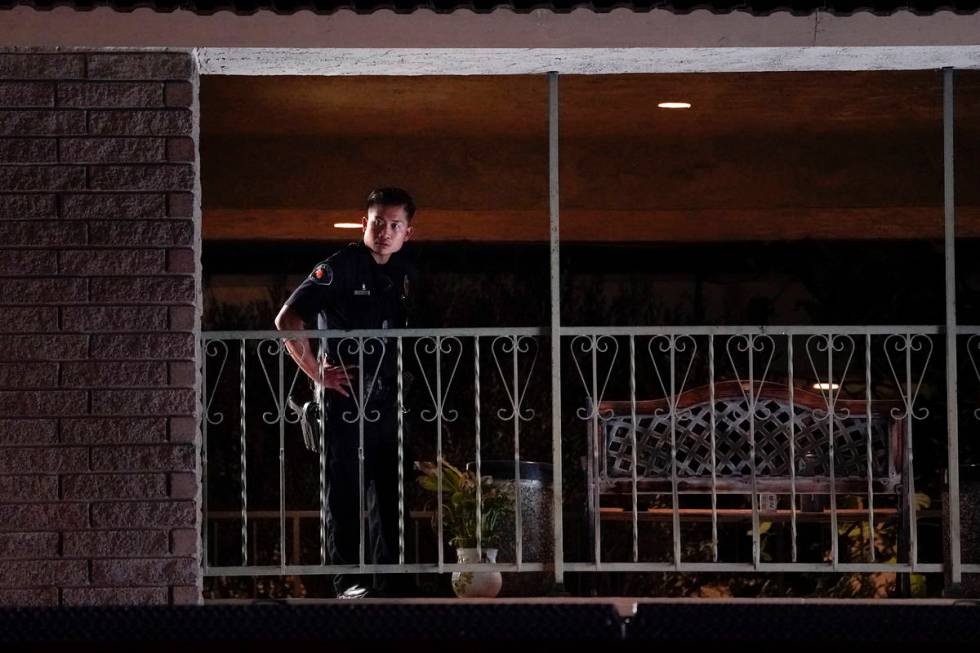 A police officer surveys the scene after a shooting at an office building in Orange, Calif., We ...