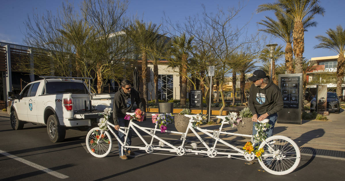 Pat Treichel, left, and Steve White with Ghost Bikes Las Vegas relocate their 5-person bike to ...