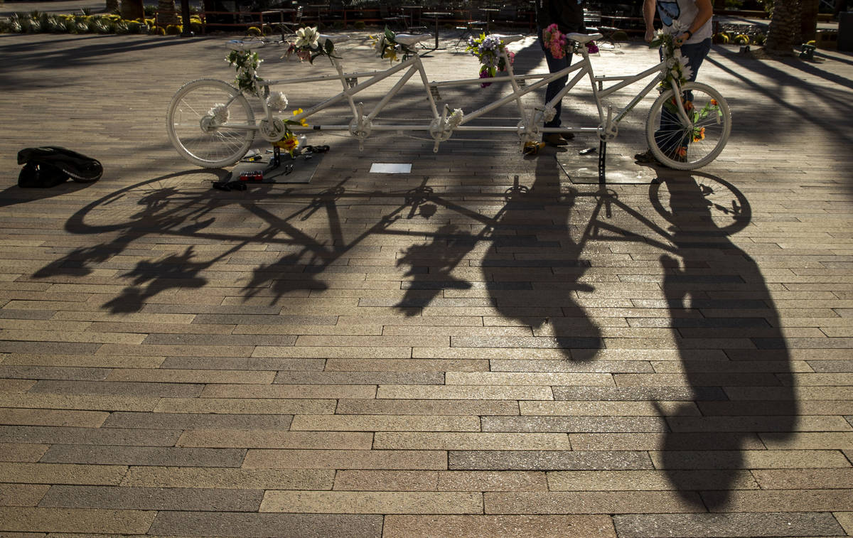 Shadows of Pat Treichel, left, and Steve White with Ghost Bikes Las Vegas as they relocate thei ...