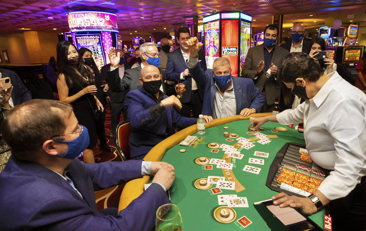 Circa casino owner Derek Stevens, top/right, celebrates after winning a big hand during the VIP ...