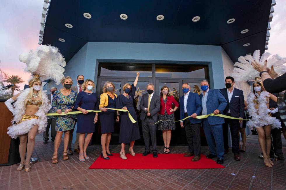 The Pass casino owner Joseph DeSimone, middle, cuts the ceremonial ribbon during opening night ...